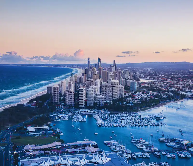 Aerial view of the Surfers Paradise towers, the beach and the Broadwater marina at dusk