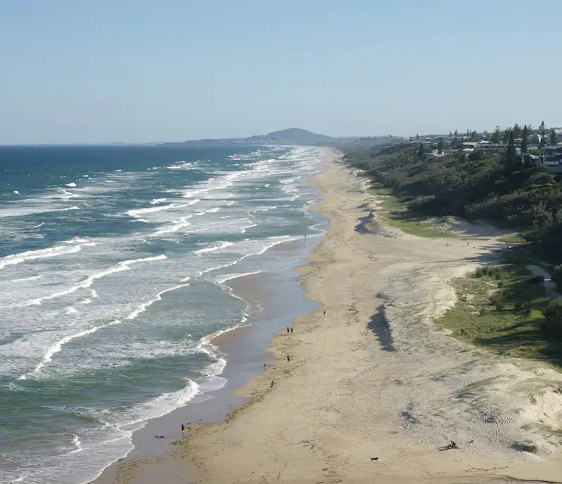 Sunshine Beach and the coastal houses above it, seen from Noosa National Park